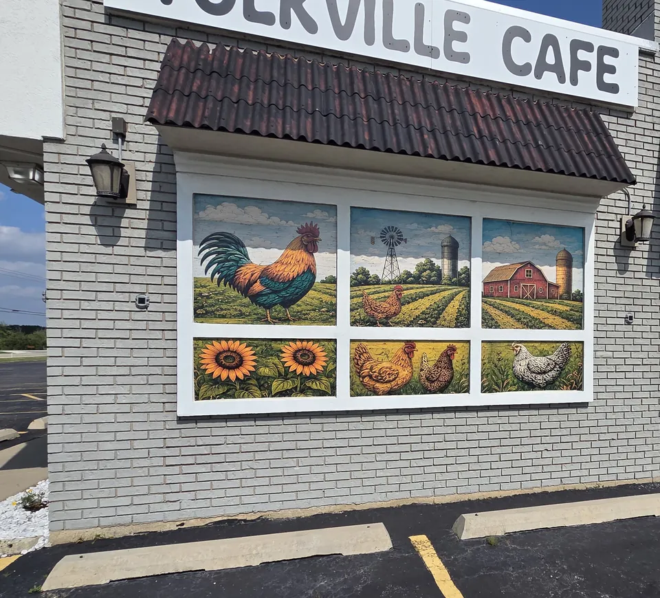 Window murals of a rooster, a barn, sunflowers and hens