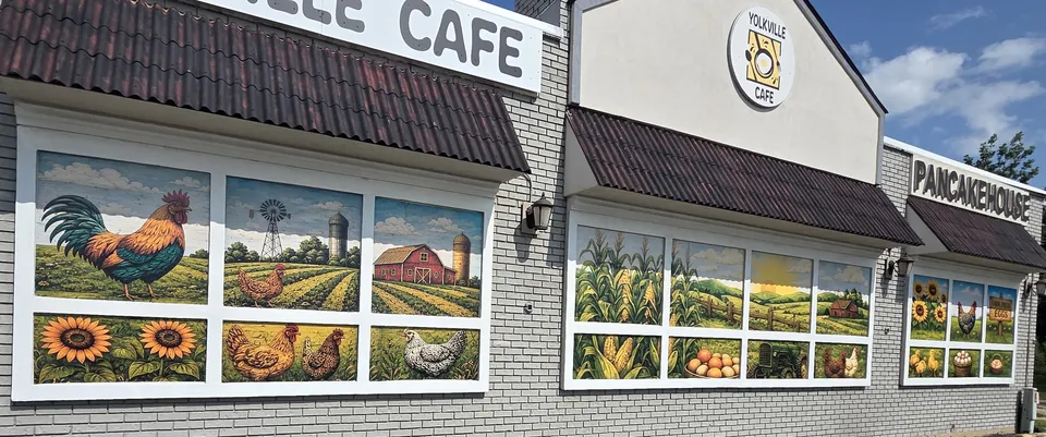Yolkville Cafe building with painted farm murals in the windows