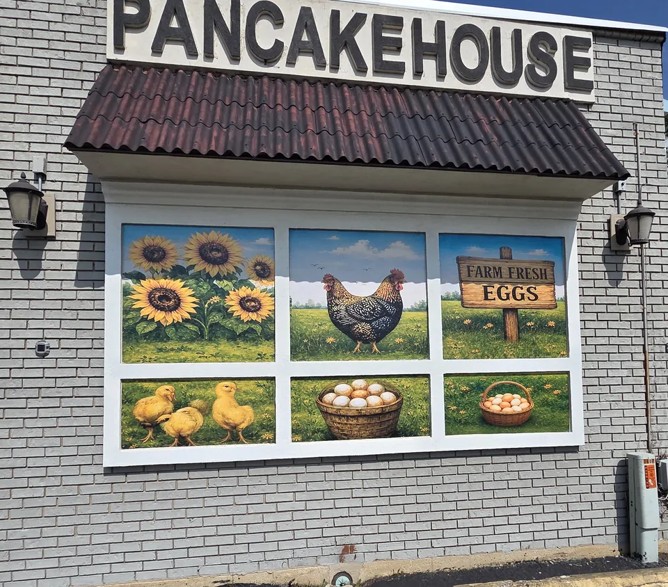 Window murals of chicks, a hen and a Farm Fresh Eggs sign